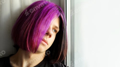 Preview: A Trendy boy with purple hair. mental health, transitional age. A color image of a teenage boy