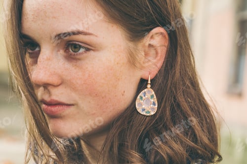 Preview: Young woman spring street portrait with freckles happy and beautiful. Girl style coat with jewelry.