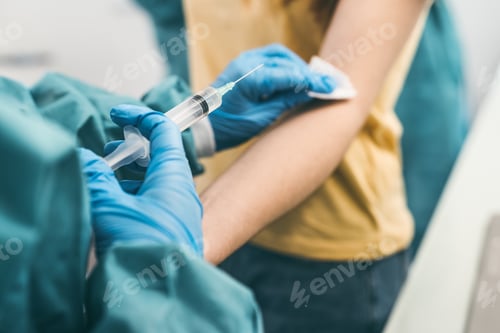 Preview: Close up woman doctor doing syringe vaccine in hospital
