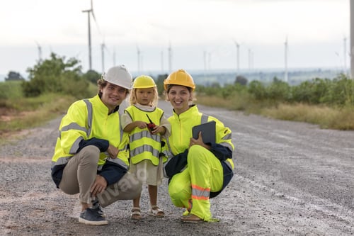 Preview: Engineer and family working at windmills.