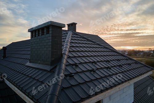 Preview: Snow guard for safety in winter on house roof top covered with ceramic shingles.