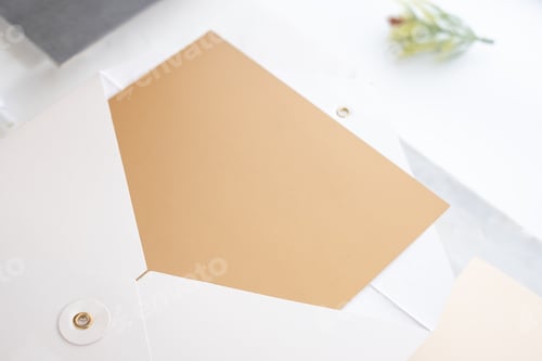 Preview: Top view of blank gold card in white envelop with pine leaf on two layer step of marble table