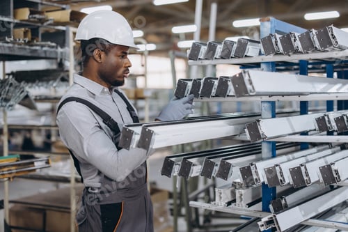 Preview: Factory worker checking aluminum and pvc window and door frames