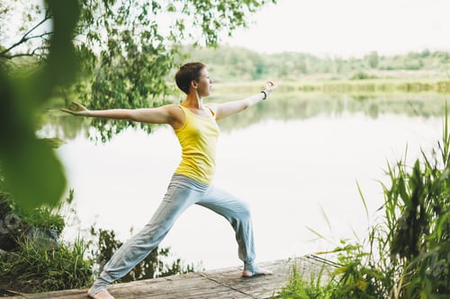 Preview: Young smiling woman practice yoga outdoors. New normal social distance