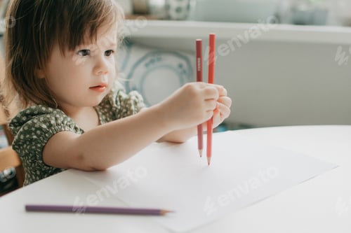 Preview: Toddler Holds Pencils Ready to Draw on Paper