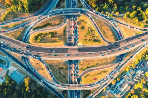 Preview: Aerial view of road in modern city at sunset in summer. Top view