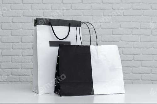 Preview: Shopping bags on a table against a textured white wall