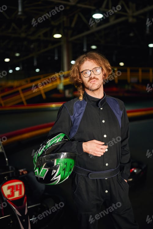 Preview: Man Stands on Go-Kart Track with Helmet