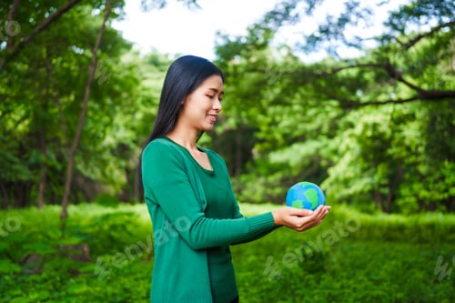 Preview: A male hand holds a hammer, symbolizing the enforcement of tree conservation laws. This highlights