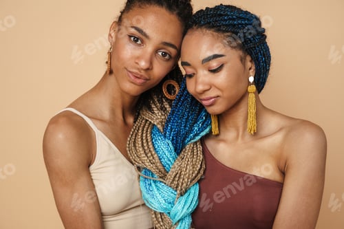 Preview: Young black two women hugging while posing on camera