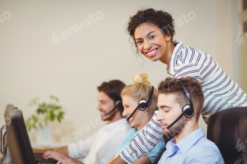 Preview: Portrait Of Smiling Businesswoman With Employees In Call Center