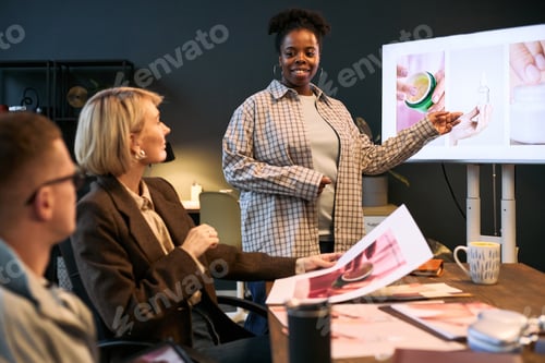 Preview: Young Black Woman Presenting Product Concepts to Diverse Colleagues in Office