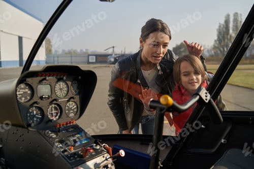 Preview: Curious child and his mother studying airplane mechanisms