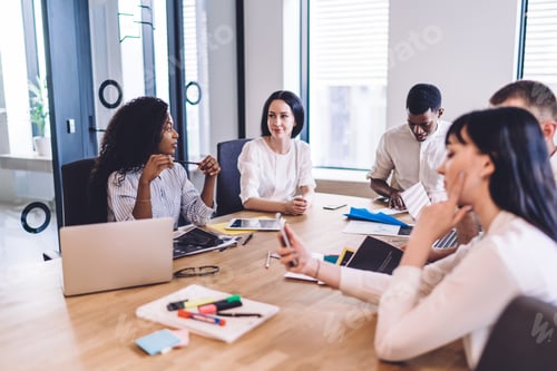 Preview: Young multiracial inventive colleagues using gadgets at business meeting at office