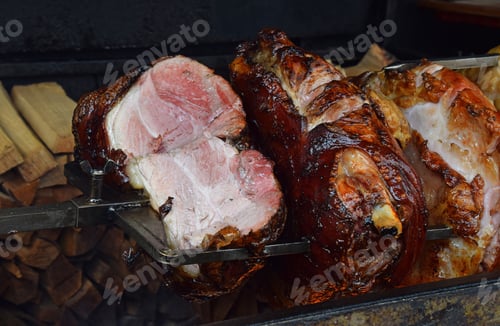 Preview: Close up pork meat roasted on open wood fire