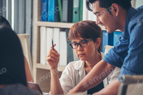 Preview: Group of business people meeting in conference room brainstorming consult business document
