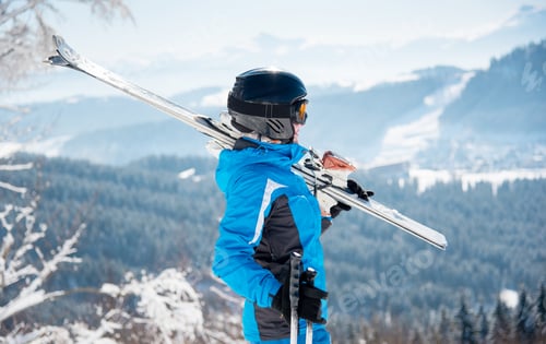 Preview: Skier resting on top of the mountain