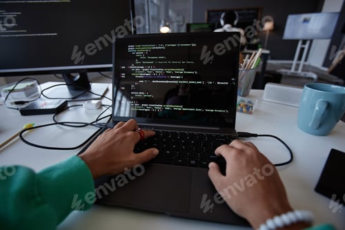 Preview: Programmer typing codes on laptop