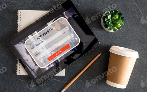 Preview: Top view of digital tablet with search job on screen on a table.