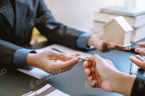 Preview: Real estate agent giving house key to the client after signing the real estate contract. Home and re