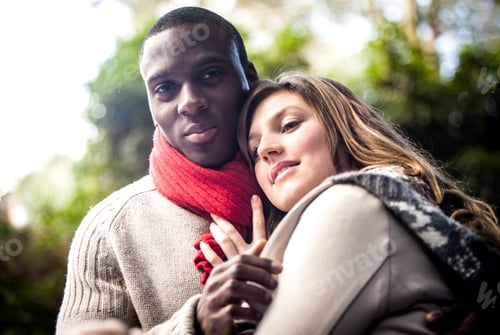 Preview: Couple embracing in a cozy outdoor setting