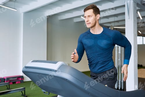 Preview: Man running on treadmill at gym