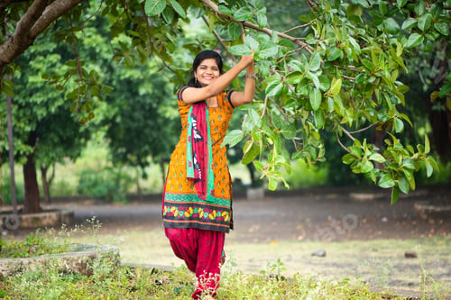 Preview: Beautiful girl between nature full of branches of tree.