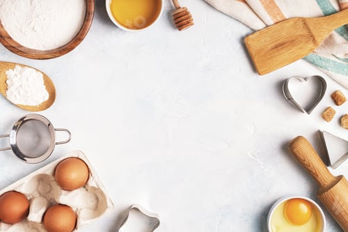 Preview: Ingredients for baking - flour, wooden spoon, eggs.
