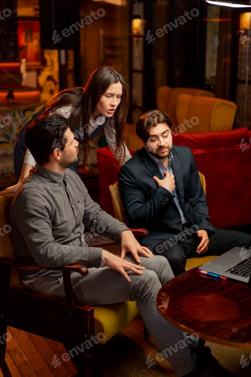 Preview: office sitting in yellow chairs two male workers discuss a project with a female director scolding