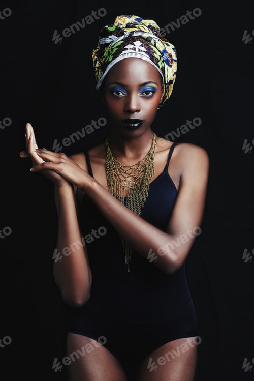 Preview: Shes a true african beauty. A beautiful african woman posing against a black background.