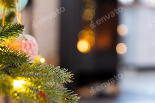 Preview: Christmas tree on the background of a burning fireplace close-up.