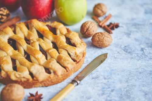 Preview: Tasty sweet homemade apple pie cake with cinnamon sticks, walnuts and apples
