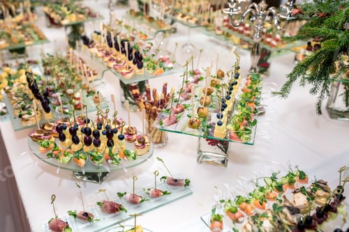 Preview: Catering. Off-site food. Buffet table with various canapes, sandwiches, hamburgers and snacks.
