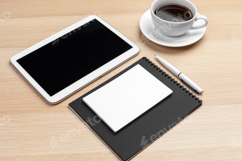 Preview: Digital tablet with notepad, supplies and coffee cup on desktop