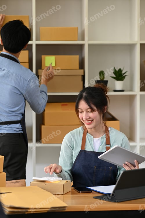 Preview: Two business partners working at warehouse for online selling.