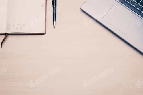 Preview: Work space table with a laptop and an agenda.