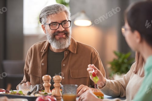 Preview: Man sitting at dining table