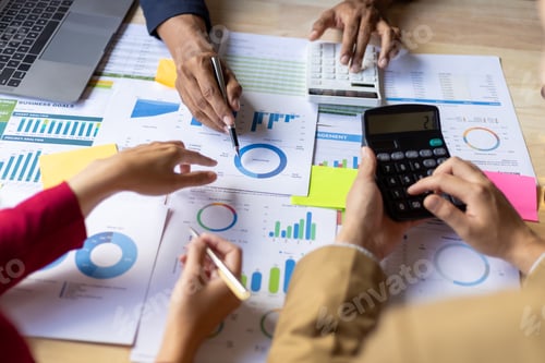 Preview: Team Discussing Charts and Graphs at Workplace Meeting