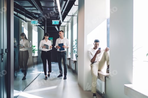 Preview: Focused partners talking at workplace