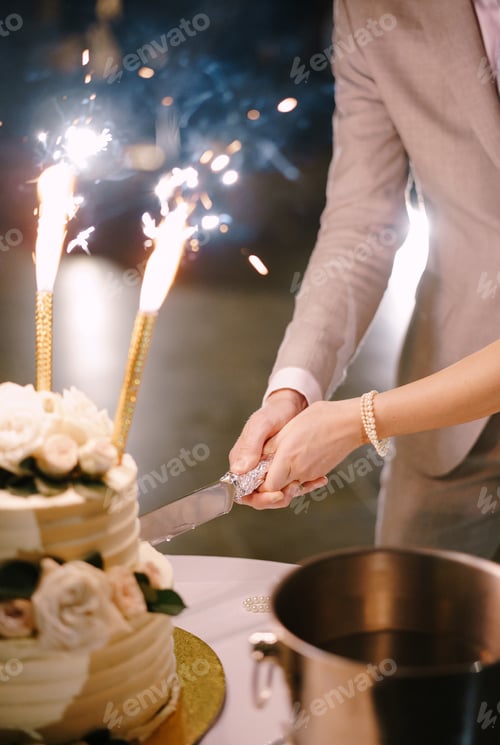 Preview: Bride and groom cut the wedding cake. Close-up