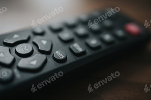 Preview: Closeup shot of remote control for TV on the wooden background