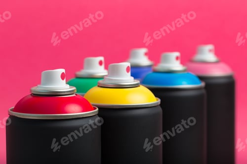 Preview: Colorful spray paint cans lined up against a bright pink background