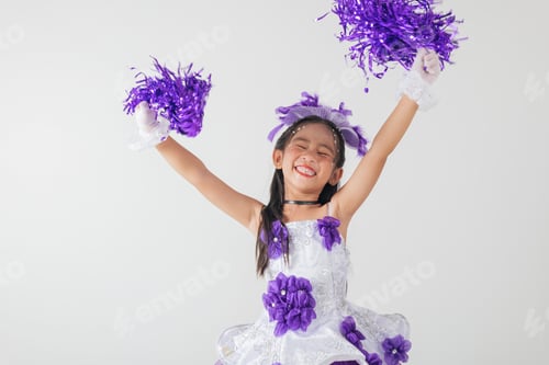 Preview: Portrait of a cheerful cheerleader girl in a purple and white outfit, holding purple pom-poms.