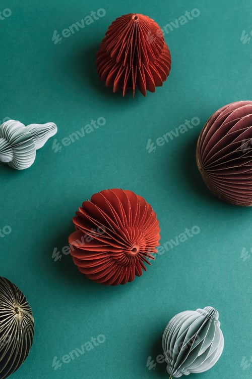 Preview: Colorful Christmas paper ornaments on green background. Pattern, top view