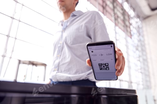 Preview: Male Passenger In Airport Departure Lounge Scanning Digital Boarding Pass On Smart Phone