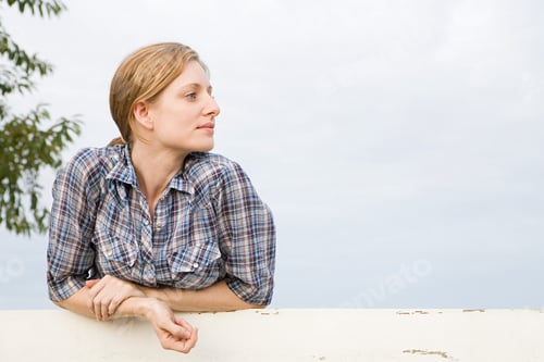Preview: Mid adut woman in paddock, looking away