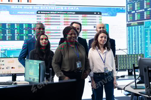 Preview: Diverse group of business professionals posing together in monitoring room