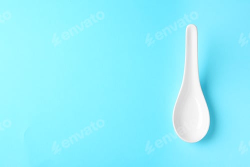 Preview: Miso soup spoon on blue background, top view. Space for text