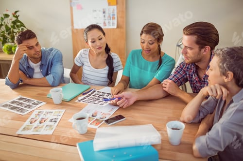 Preview: Seated Creative Business Team Working Together In The Office