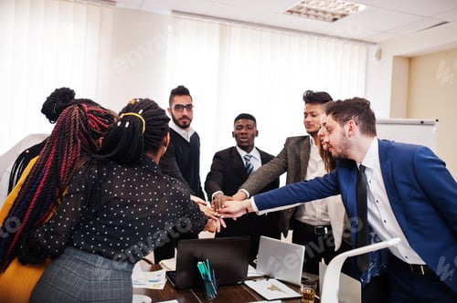 Preview: Multiracial young creative people in modern office